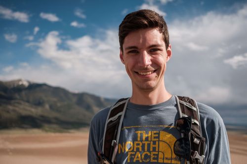 Photo of John Matychuk standing outside in Great Sand Dunes National Park.